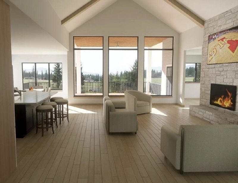 Open kitchen and living area with a vaulted ceiling and large windows