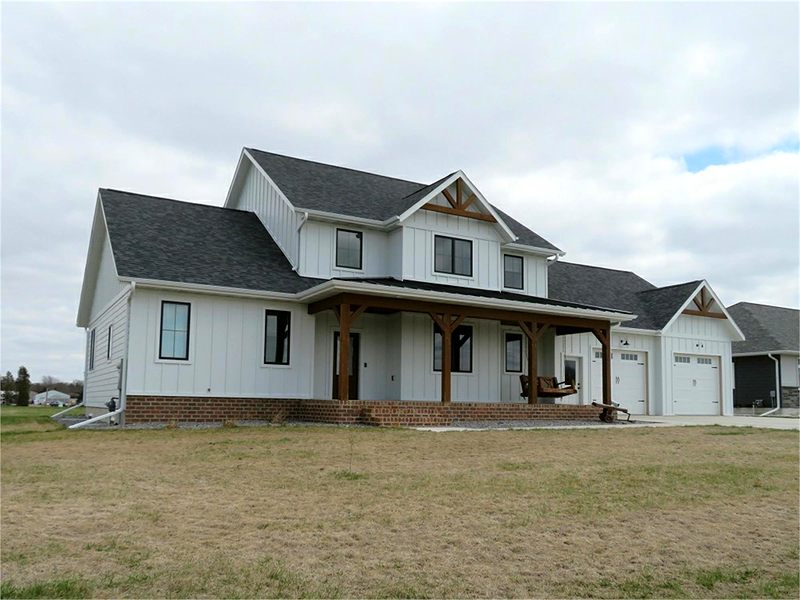 White farmhouse with a timber-frame front porch