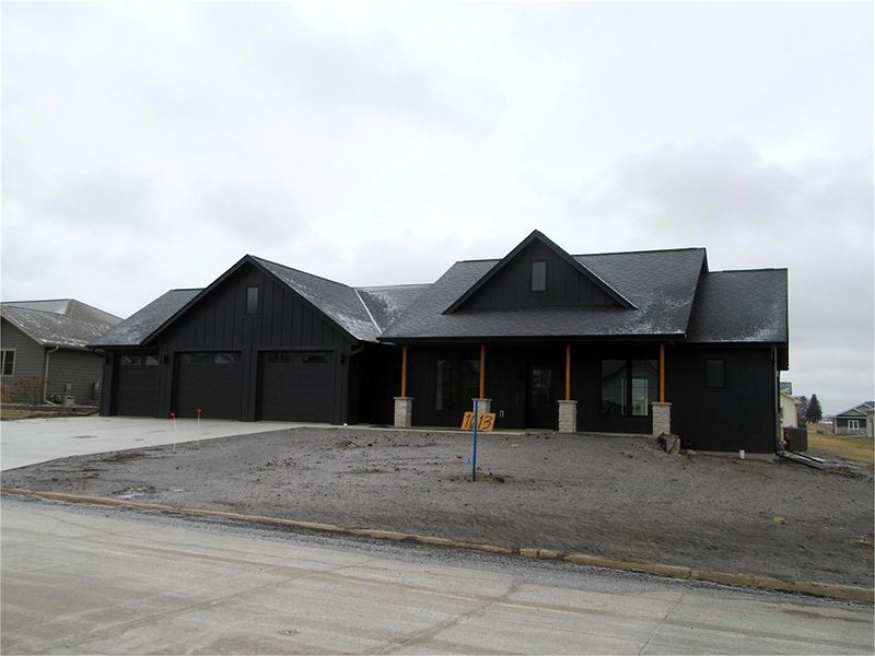 Black modern farmhouse with timber porch posts