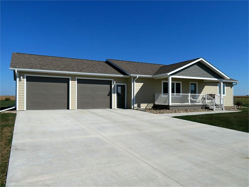 Ranch home with a covered front porch and a wide driveway