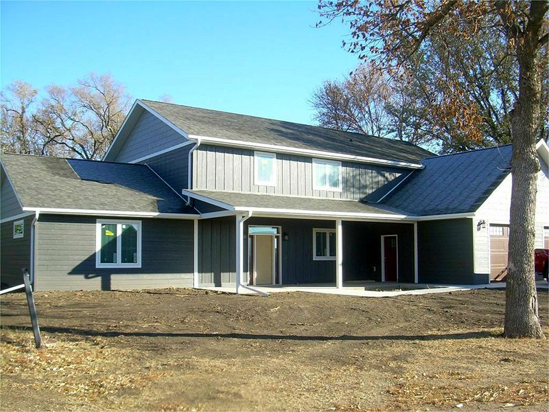 Two-story blue home with a covered entry