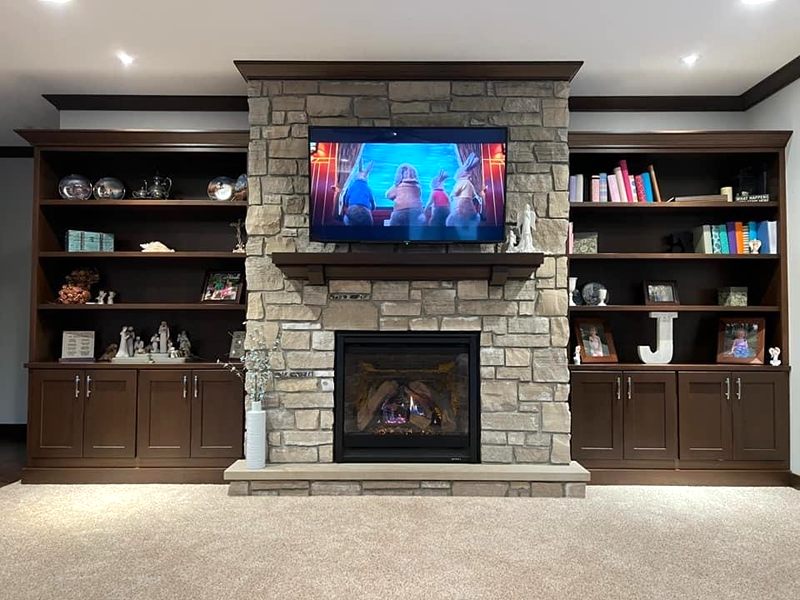 Stacked stone fireplace wall with built-in shelving