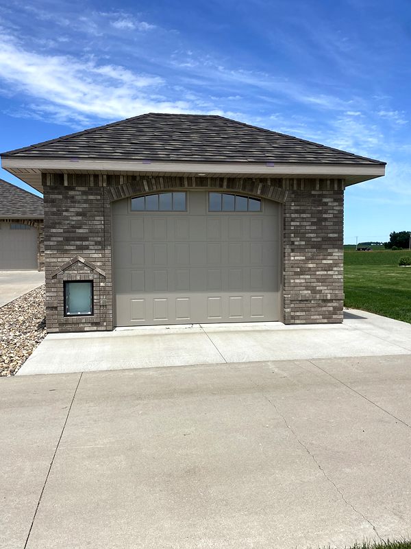 Detached garage with a stone veneer front